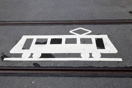 A road marking tram warning sign painted on the tramway.の写真素材