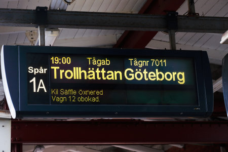 Karlstad, Sweden - July 13, 2019: Platform departure information sign with departure time for passenger train operated by Tagab with destinations Trollhattan and Gothenburg.のeditorial素材