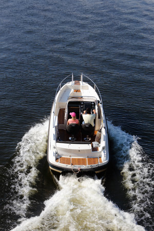 Stockholm, Sweden - July 8, 2014: A man and a woman in pleasure open motor boat.