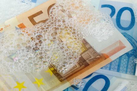 Full frame image of euro banknotes in various denominations in soap water.の写真素材