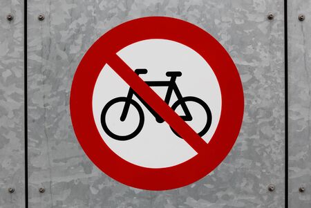 No cycles or small mopeds road sign painted on a wall.