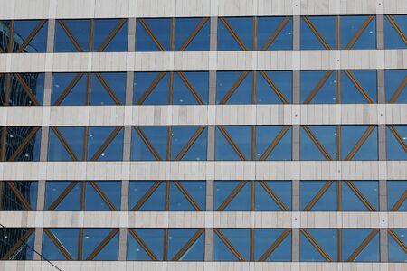 Modern office building with large windows and with crisscrossing beams.の写真素材