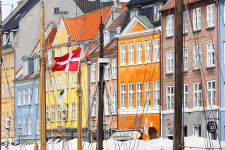 Copenhagen, Denmark - September 4, 2019: Dansh flag in one of the ships masts in the Nyhavn harbor...