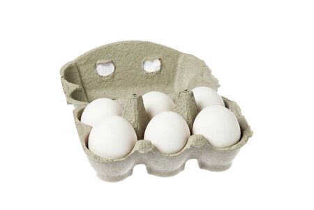 One open egg carton containg six eggs isolated on white background.