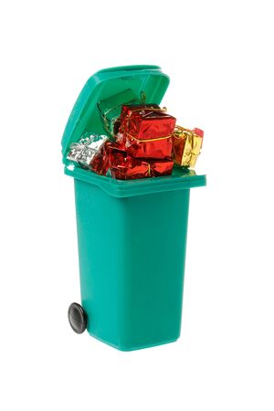 Green garbage bin filled with wrapped gift boxes isolated on white background.の写真素材