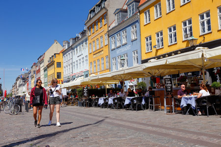 Copenhagen, Denmark - June 27, 2018: Street view of the Nyhavn pedestrians only street with its restaurants an colorful old buildings.のeditorial素材