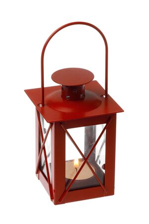Red colored decorative metalic small lantern with a  lit tealight inside isolated on white background.の写真素材