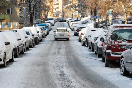Solna, Sweden - December 10, 2019: View of the urban snow covered Virebergsvagen street with traffic and parked cars.のeditorial素材