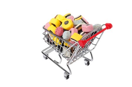 Rear view of a shopping cart filled with assorted English liquorice candy isolated on white background.の写真素材