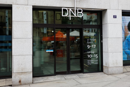Oslo, Norway - June 20, 2019: Exterior view of the DNB bank office entrance at the 27 Karl Johans gate situated in the downtown district.のeditorial素材