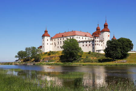 Lacko, Sweden - June 23, 2020: A canoeist in a kayak paddles past LÃ¤ckÃ¶ castle.のeditorial素材