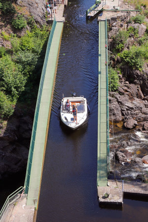 Haverrud, Sweden - June 24, 2020: A couple travels with their motorboat on the aqueduct which is part of Dalsland's canal in Haverud.のeditorial素材