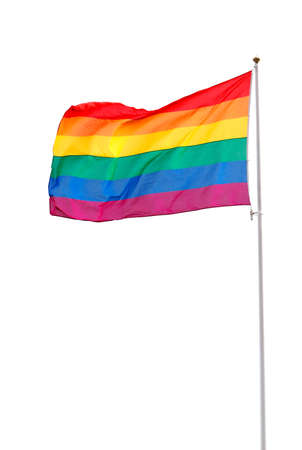Rainbow flag waving hoisted on mast isolated on white background.の写真素材