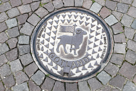 Visby, Sweden - October 4, 2020: A manhole cover with Swedish province of Gotland coat of arms.のeditorial素材