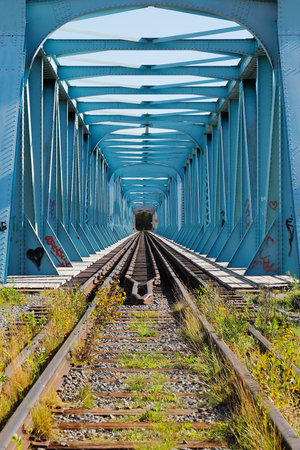 Blue steel railroad bridge with dual gauges at the national border between Sweden and Finland.の写真素材