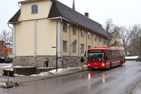 Sodertalje, Sweden - February 20, 2021: A red bus on line 754 stationary at the sop behind the old city hall at the Kopangatan street.のeditorial素材