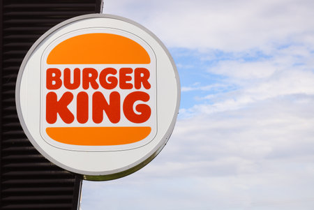 Eskilstuna, Sweden - May 17, 2021: The Burger King new rebranded logo on a billboard outside the restaurant.のeditorial素材