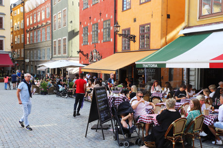 Stockholm, Sweden - July 29, 2021: Outdoor seating at restaurants located at the Stortorget square in the Old town.のeditorial素材