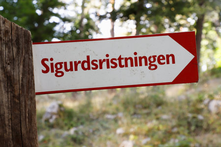 Signpost with direction to the runic rock carving Sigurdristningen near Eskilstuna in the Swedish...