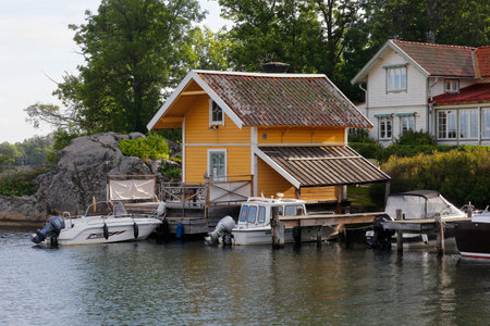 Vaxholm, Sweden - August 30, 2019: View of residential seaside single family home with jetty.のeditorial素材