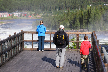Vidsel, Sweden - August 23, 2021: A family visiting the Storforsen rapids in the Pite river.のeditorial素材