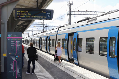 Sodertalje, Sweden - September 3, 2021: Commter train for Uppsala stationary at the platform at the...