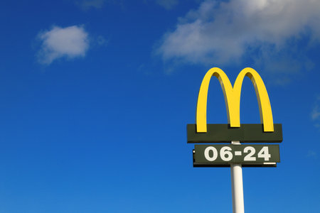 Nykvarn, Sweden - September 4, 2021: Close-up view of McDonald's fast food chain logotype with open hours.のeditorial素材