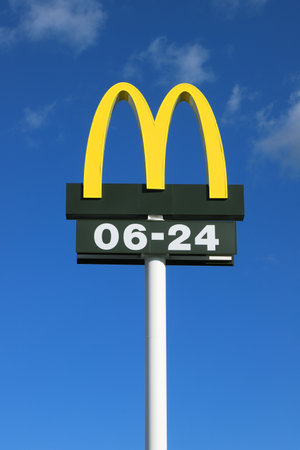 Nykvarn, Sweden - September 4, 2021: Close-up view of McDonald's fast food chain logotype with open hours.のeditorial素材
