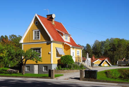 Yellow house single-family house with tiled gabled roof on two floors with basement built in the 1920s.の写真素材
