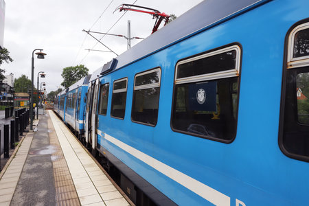 Osterskar, Sweden - August 16, 2021: The narrow gauge Roslagsbanan service commuter train at the Osterskar terminus railroad station.のeditorial素材