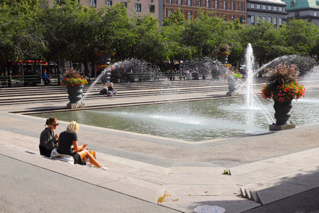 Stockholm, Sweden - Septeber 1, 2021: People resting near the fountain in the Kungstradgarden park.のeditorial素材