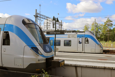 Sodertalje, Sweden - September 3, 2021: View of two class X60 commuter trains in service for SL in greater Stockholm area at the Sodertalje hamnn railroad station.のeditorial素材
