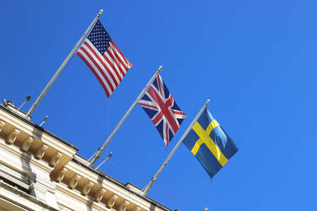 Low angle view of flag representig the USA, Great Britain and Sweden.の写真素材