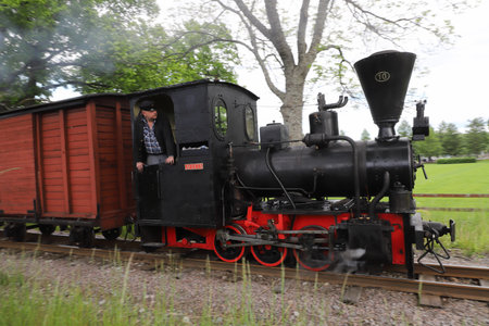 Mariefred, Sweden - June 4. 2022: Steam locomotive number 10 Avesta with traiver pulling a narrow gauge museum train.のeditorial素材
