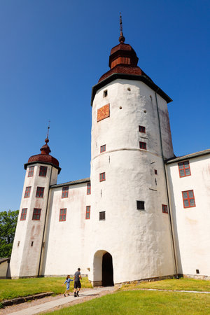 Lacko, Sweden - June 23, 2020: An adult and a child visit the medieval Lacko castle through the main gate. The construction of Lacko castle began during the 13th century.のeditorial素材