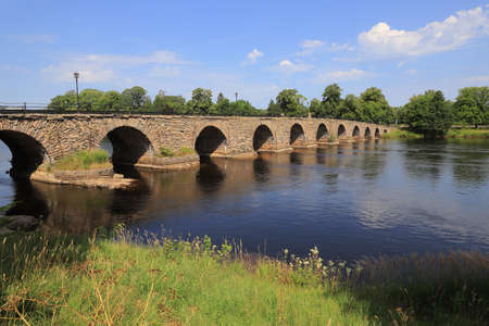 The long stone arch bridge from the 18th century bridges over the river Klaralven in Karlstad city.