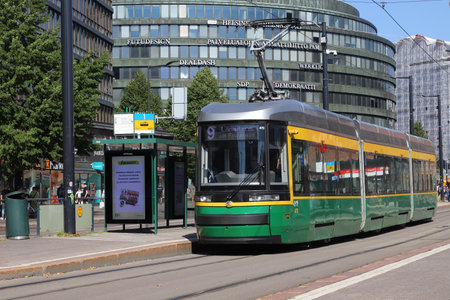 Helsinki, Finland - August 20, 2022: Green articulated tram in service on line 9 at the Hakaniemi square.のeditorial素材
