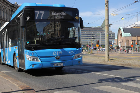 Helsinki, Finland - August 20, 2022: Blue electric powered city bus on line 77 outside the Central railroad station.のeditorial素材