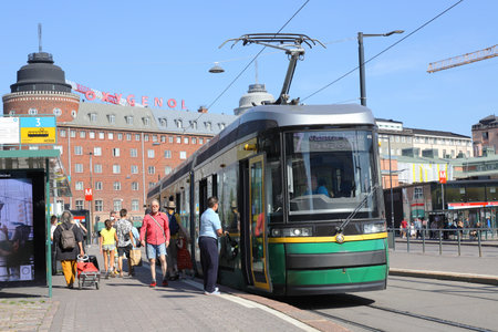 Helsinki, Finland - August 20, 2022: Atriculated tram on line 7 and people at the Hakaniemi stop.のeditorial素材
