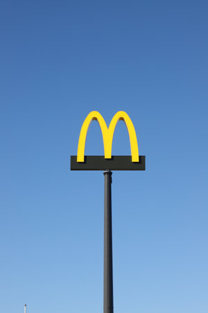 Torni, Finland - August 29, 2022: The McDonalds fast food restaurant logotype against a blue sky.のeditorial素材