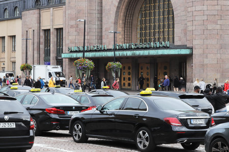 Helsinki, Finland - September 5, 2023: Taxis waiting in line at the taxi stand outside the Helsinki railroad station.のeditorial素材