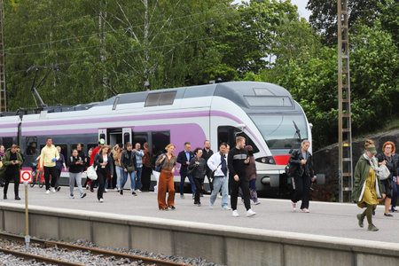 Helsimki, Finland - September 5, 2023: Passenger disembarking the HSL commuter train class Sm5, Stadler Flirt at the Helsinki Central station.のeditorial素材