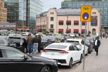 Helsinki, Finland - September 5, 2023: Taxi stand with cabs waiting outside the Helsinki Central railroad station.のeditorial素材