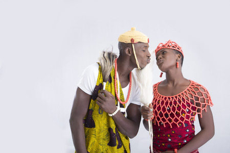 Young couple in traditional attire blowing a kissの写真素材