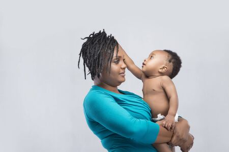 A woman carrying her baby boyの写真素材