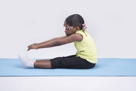 A little girl stretching on isolated backgroundの写真素材