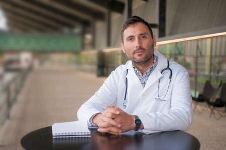 handsome doctor in a technologic medical center with a worried grinの写真素材