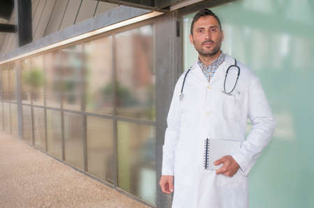 handsome doctor in a technologic medical center with a worried grinの写真素材