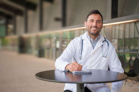 handsome doctor in a technologic medical center with a smileの写真素材