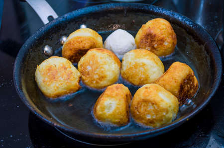 Cottage cheese donuts are fried in a skilletの写真素材